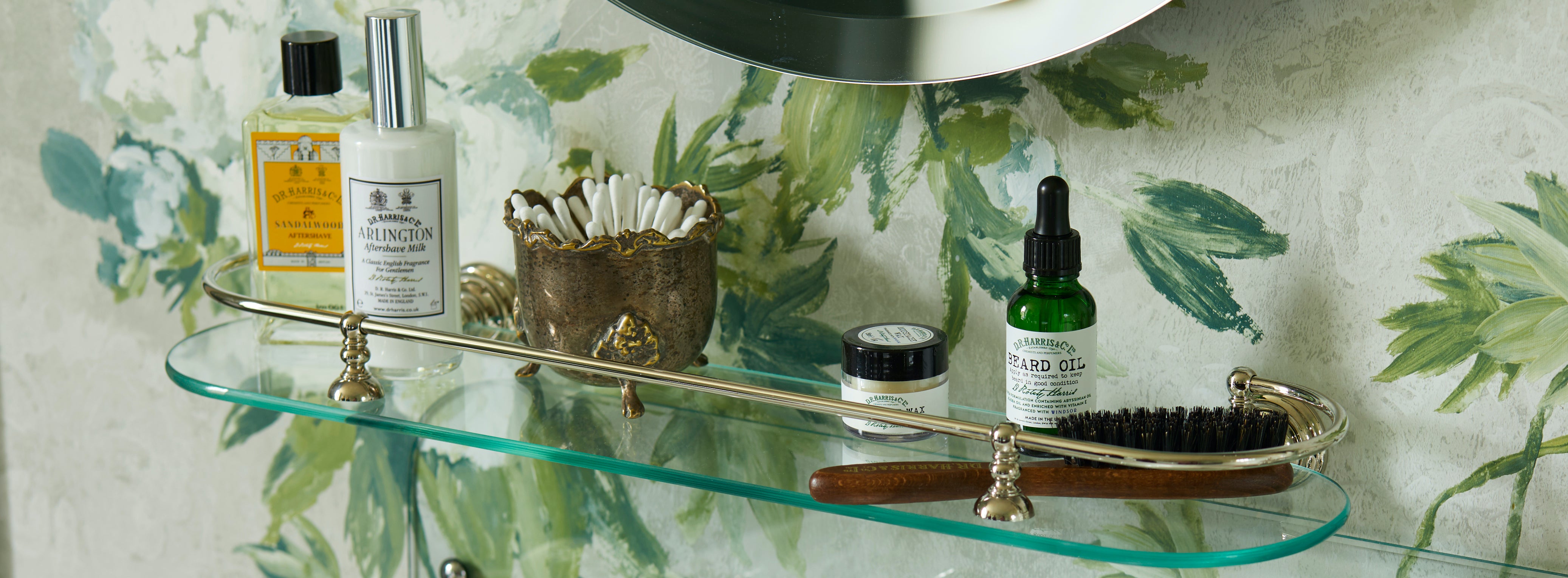 assortment of grooming products on a glass shelf