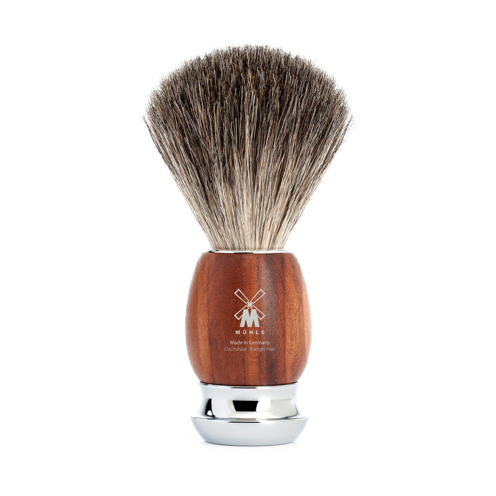 Shaving brush with wooden handle and silver ferrule on a white background