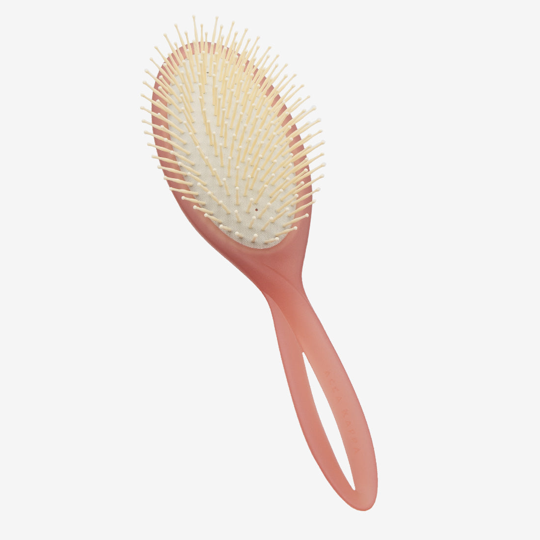 Pink hairbrush with bristles on a light gray background