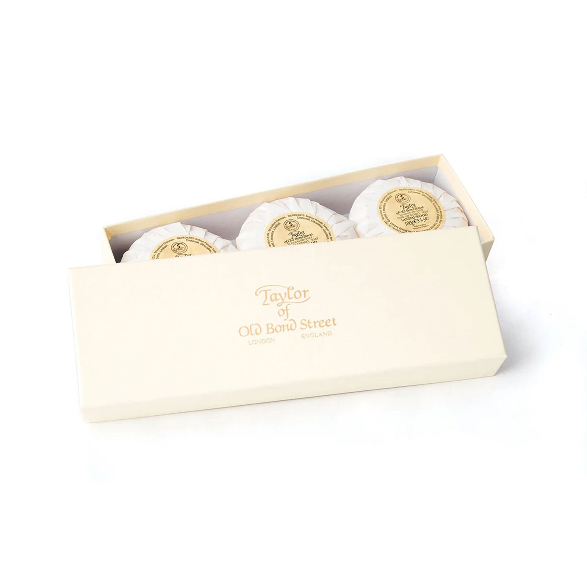 Three sandalwood soaps in a box with 'Taylor of Old Bond Street' branding on a white background