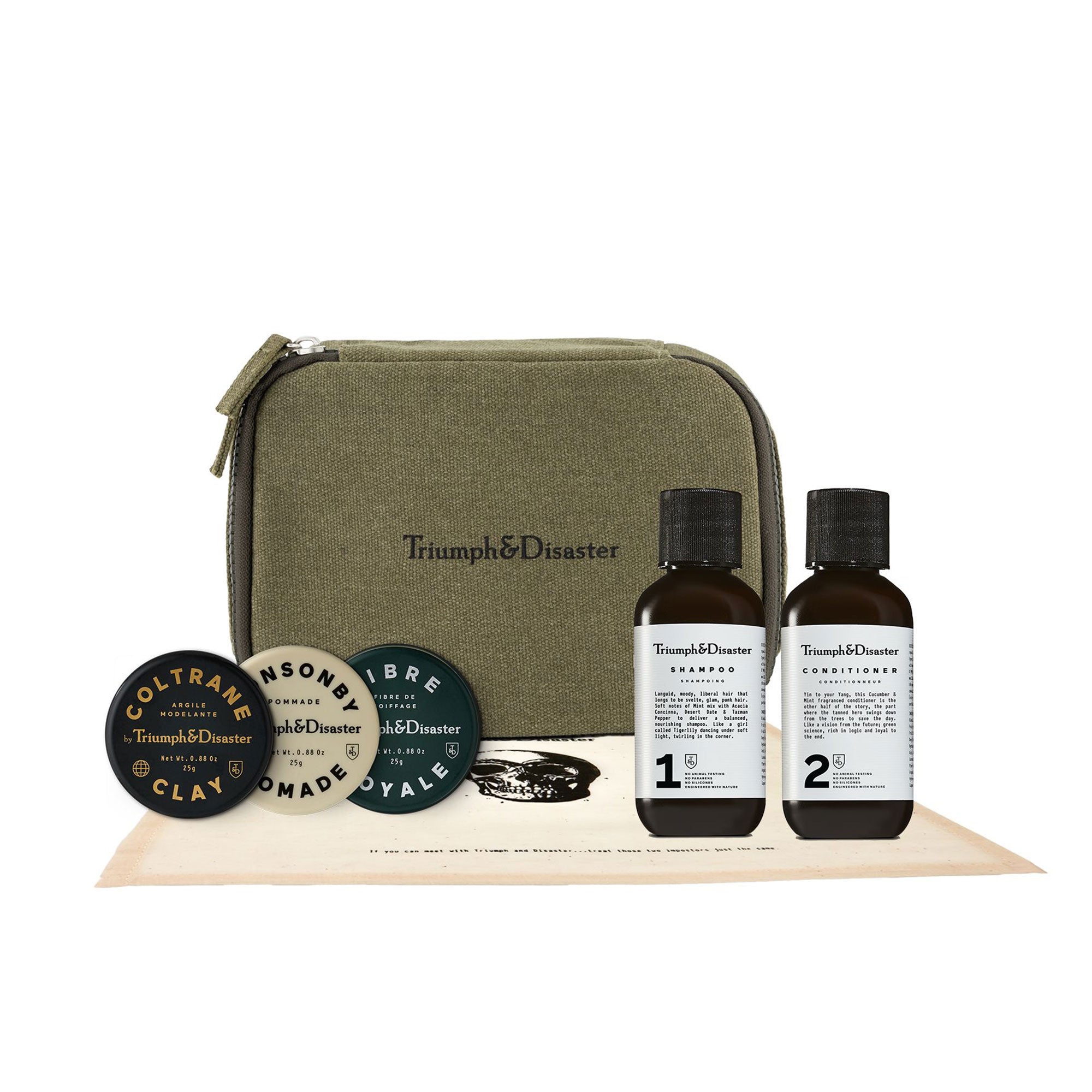 Grooming kit with bottles, containers, and a green case labeled 'Triumph & Disaster' on a white background.
