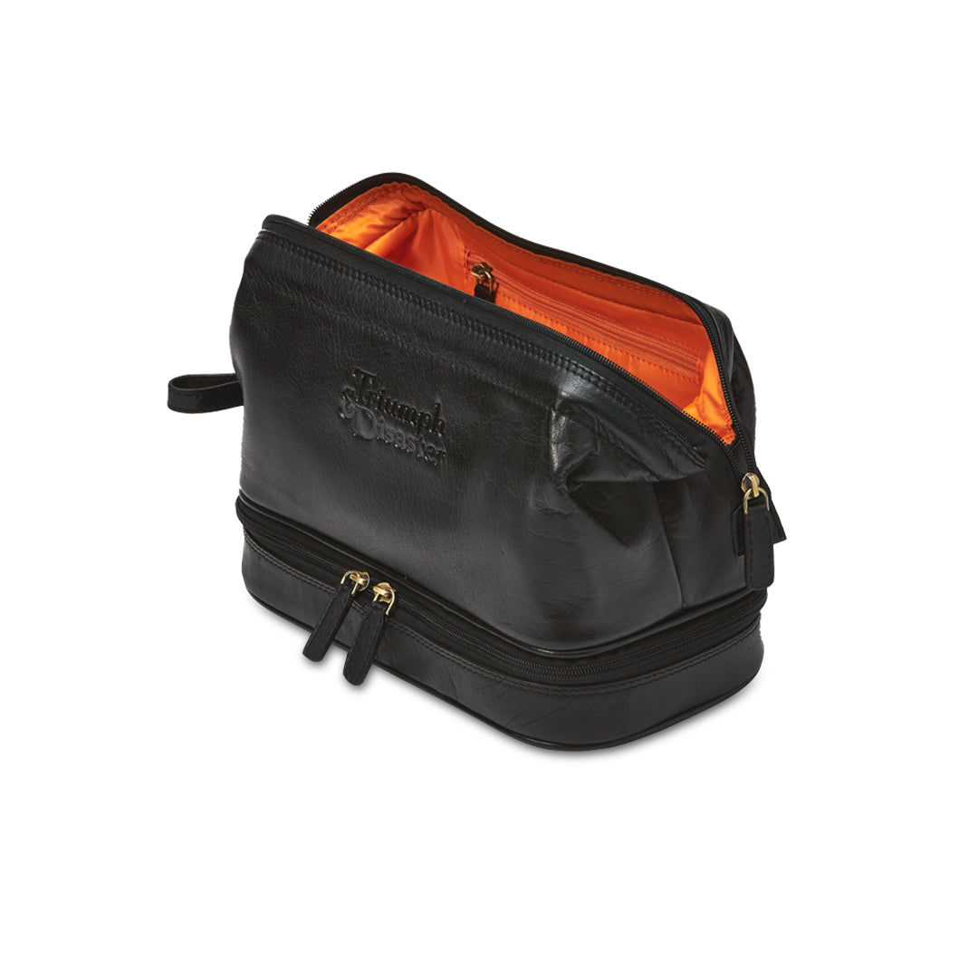Black toiletry bag with orange interior on a white background